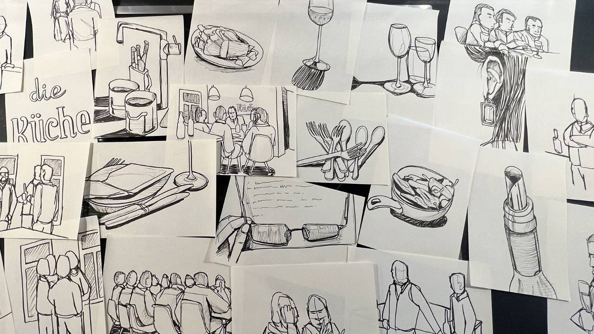 Ausgelegte Illustrationen mit Figuren, Schriftzügen und experimentellen Zeichnungen.